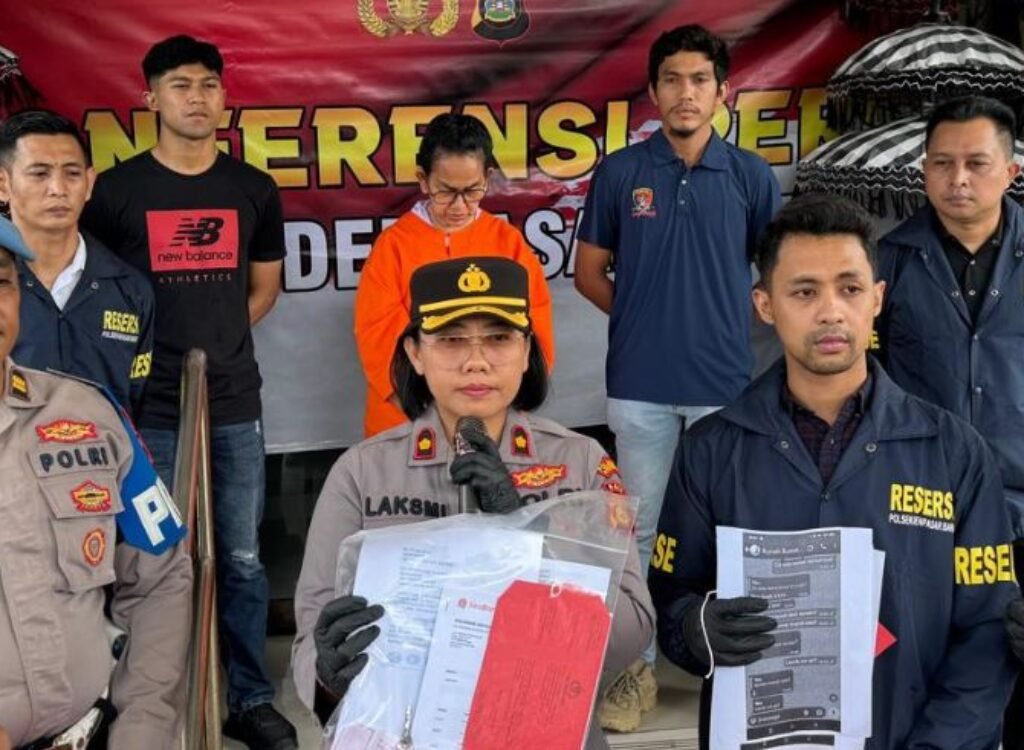 Maharani Aisyah Rasyid presented by police following her arrest in the shop rental fraud case.