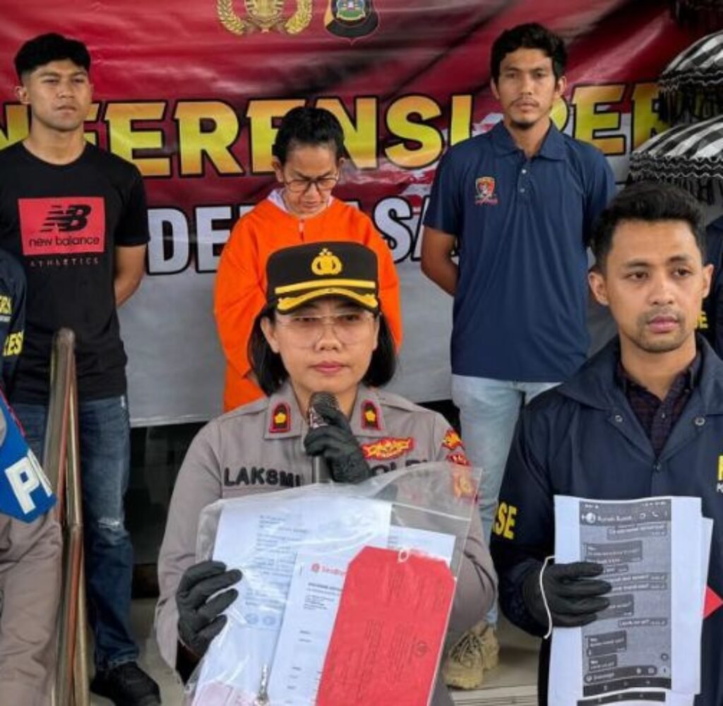 Maharani Aisyah Rasyid presented by police following her arrest in the shop rental fraud case.