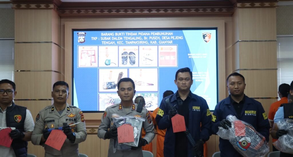 Police officers present evidence related to the murder case during a press conference at Gianyar Police Headquarters.